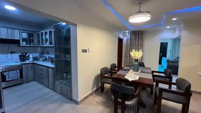 a kitchen and dining room with a table and chairs at ENDITO Villas in Arusha