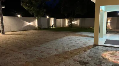 an empty courtyard at night with a building at ENDITO Villas in Arusha