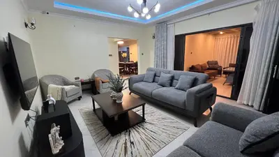 a living room with a couch and a table at ENDITO Villas in Arusha