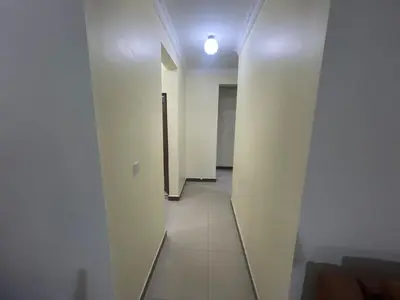 an empty hallway with a door and a hallwayngthngthngthngthngthngthngth at Arusha Serenity Apartment in Arusha