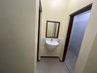 a bathroom with a sink and a mirror at Arusha Serenity Apartment in Arusha