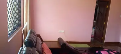 a person sitting on a couch looking out a window at Sauda Homestay in Arusha