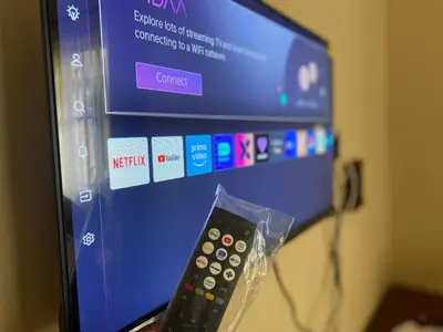 a remote control sitting in front of a tv at Kili Spring Hotel in Arusha