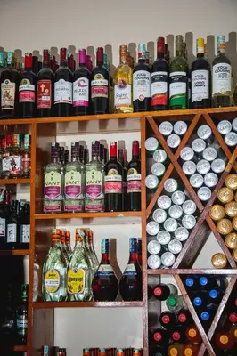 a shelf filled with lots of bottles of alcohol at Kili Spring Hotel in Arusha