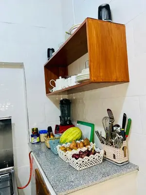 a kitchen counter with two baskets of food on it at The Dawn cottage in Moshi