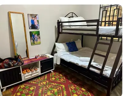 a bedroom with two bunk beds and a mirror at Samirehousea in Msaranga