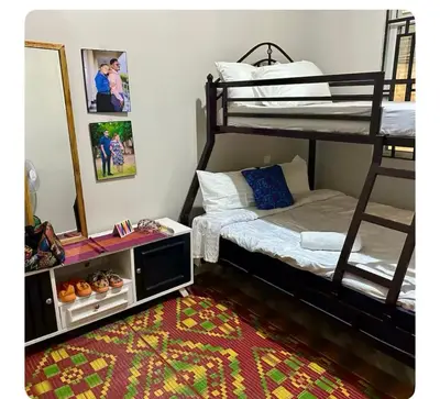 a bedroom with two bunk beds and a mirror at Samirehousea in Msaranga