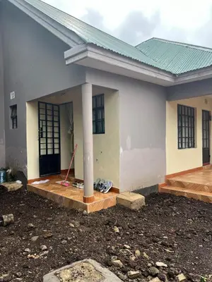 a house is being constructed with a porch and a pole at 'La Maison' 2 bedroom house in Arusha in Arusha