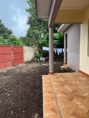 a porch with a wooden floor and a fence at 'La Maison' 2 bedroom house in Arusha in Arusha