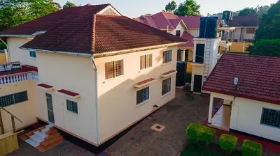 an overhead view of a white house with a red roof at Kwetu Hostel in Arusha