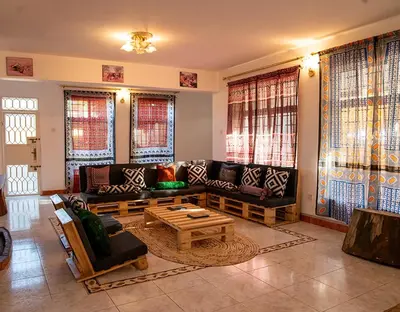 a living room with couches and a coffee table at Kwetu Hostel in Arusha