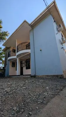 a building with a large door on the side of it at Homeland Apartments in Arusha
