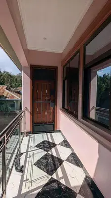 a balcony with a tiled floor and two windows at Homeland Apartments in Arusha