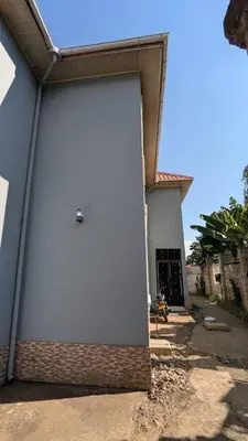 a large white door on the side of a building at Homeland Apartments in Arusha