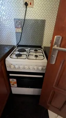 a white stove top oven in a kitchen at Homeland Apartments in Arusha