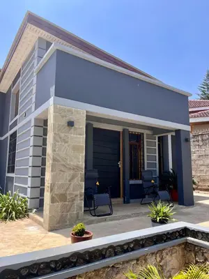 a small house with a patio at Abasimba House Arusha in Themi