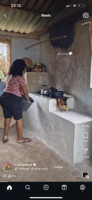 a woman standing in a kitchen preparing food at Abasimba House Arusha in Themi