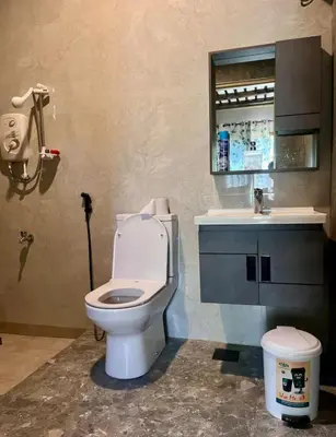 a bathroom with a toilet and a sink at Abasimba House Arusha in Themi