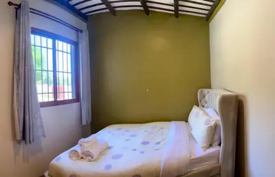 a bedroom with a bed with towels on it at Abasimba House Arusha in Themi