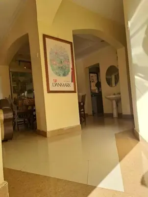 a living room with a picture on the wall at Villa Jane in Arusha in Arusha