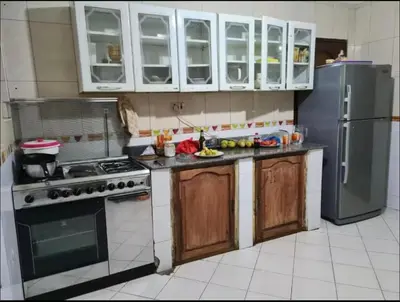 a kitchen with a stove and a refrigerator at Villa Jane in Arusha in Arusha