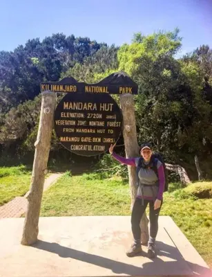 a person standing in front of a sign at Villa Jane in Arusha in Arusha