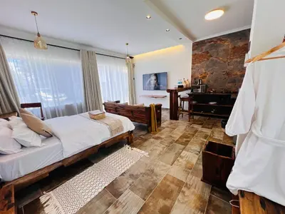 a bedroom with a bed and a desk in a room at City Retreat Studio X in Arusha