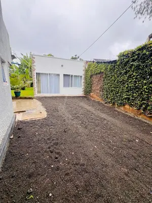 an empty driveway in front of a white building at City Retreat Studio X in Arusha