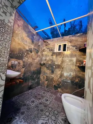 a bathroom with a sink and a tub and a toilet at City Retreat Studio X in Arusha
