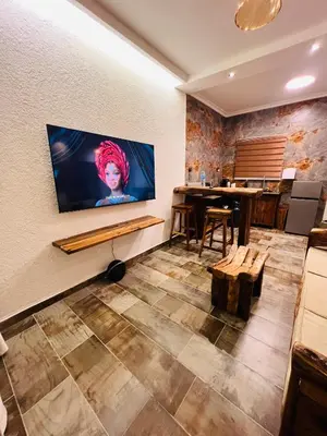 a room with a flat screen tv on a wall at City Retreat Studio X in Arusha