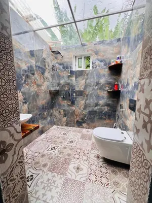 a bathroom with a tub and a toilet in a room at City Retreat Studio X in Arusha