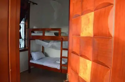 a room with two bunk beds and a window at Barazani Garden House in Moshi