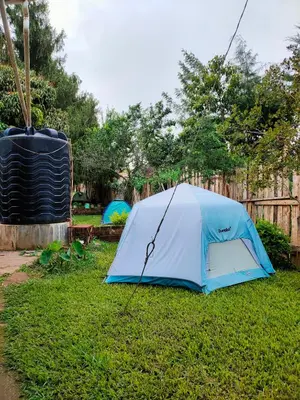 a blue tent sitting on the grass in a yard at Bright Michelle Homestay in Lushoto