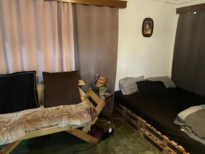 a room with two twin beds and a window at Jibambe campsite in Moshi