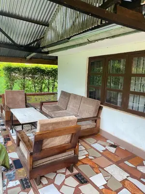 a living room with a couch and chairs on a tile floor at Jibambe campsite in Moshi
