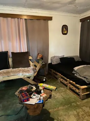 a living room with two beds and a table at Jibambe campsite in Moshi