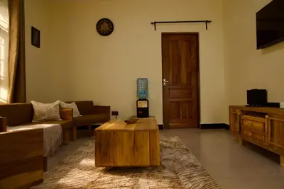 a living room with a couch and a coffee table at Nyumbani Nyumbani in Arusha