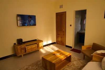 a living room with a couch and a coffee table at Nyumbani Nyumbani in Arusha