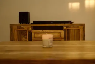 a candle sitting on top of a table with a speaker at Nyumbani Nyumbani in Arusha