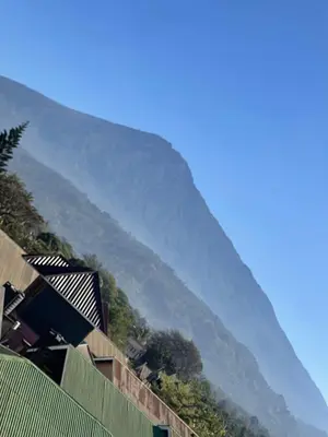 a mountain in the distance with houses and trees at QD Apartment in Arusha