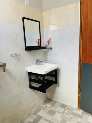 a bathroom with a sink and a mirror on the wall at leo apartment in Arusha