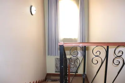 a room with a balcony with a window at Madalina's Appartment in Arusha