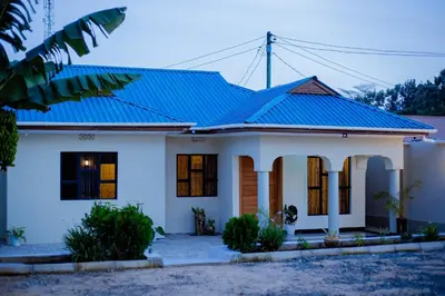 a house with a blue metal roof at Amellie's Home Safari in Nkunjila