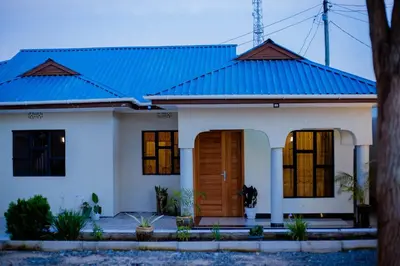 a house with a blue roof at Amellie's Home Safari in Nkunjila