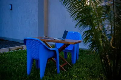 a table and two chairs with a laptop on it at Amellie's Home Safari in Nkunjila