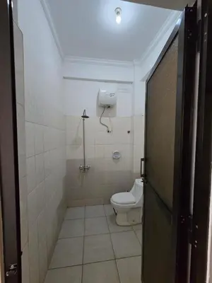 a bathroom with a toilet and a shower at Twiga Hotel - Tulivu Urban in Moshi