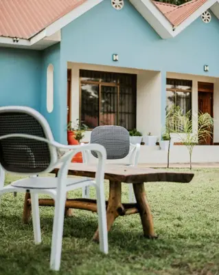 a picnic table and chairs in front of a house at D&G Homes Apartments in Arusha