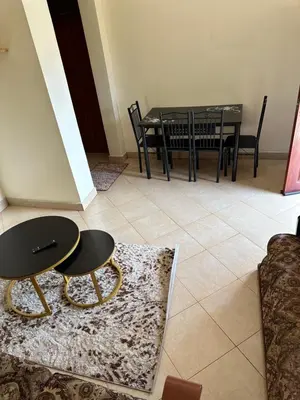 a dining room with a table and a table and chairs at Vicol luxe stay in Arusha