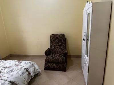 a bedroom with a chair next to a bed at Vicol luxe stay in Arusha
