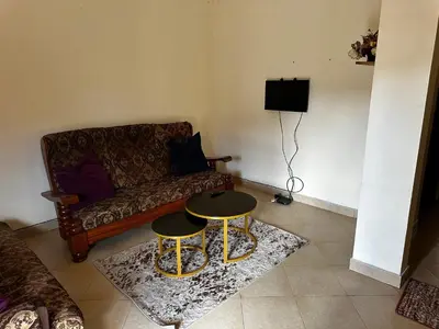 a living room with a couch and a table at Vicol luxe stay in Arusha